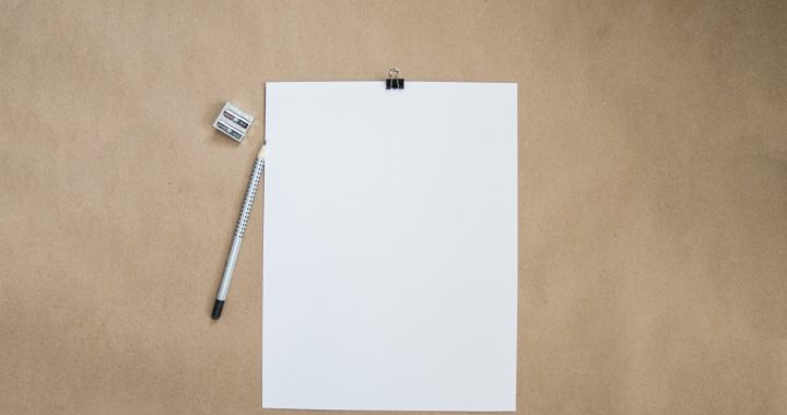 Blank sheet of paper and a pencil on a desk