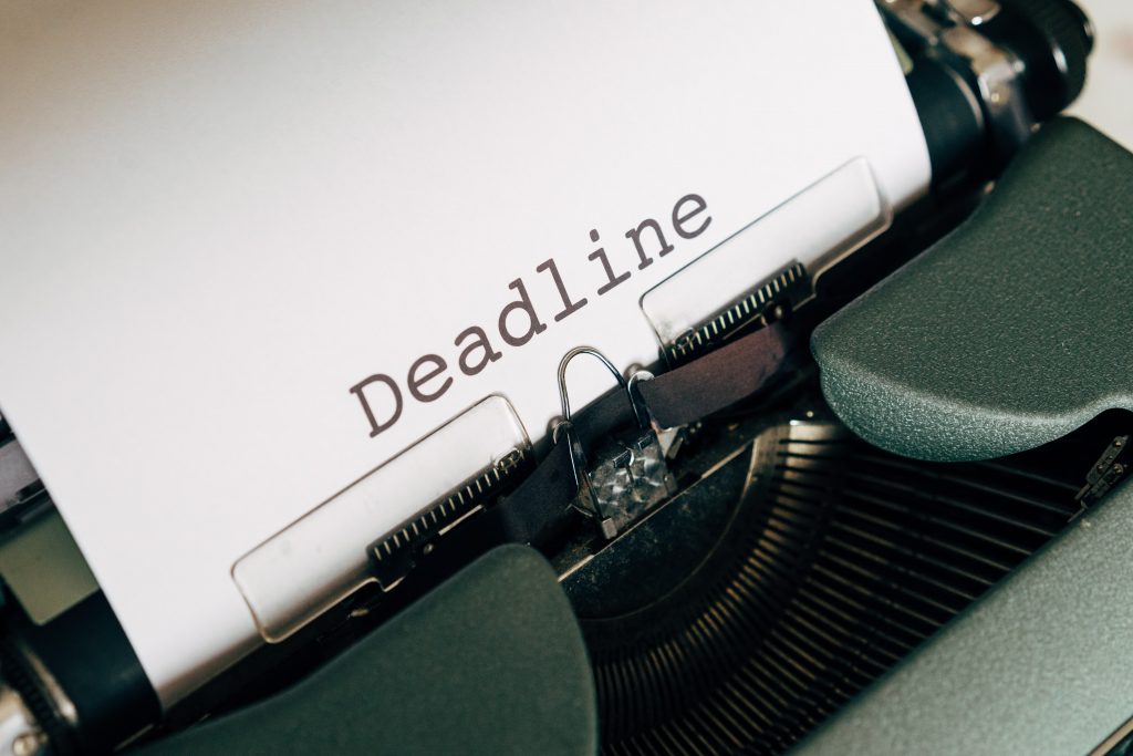 Typewriter with a piece of paper that says deadline